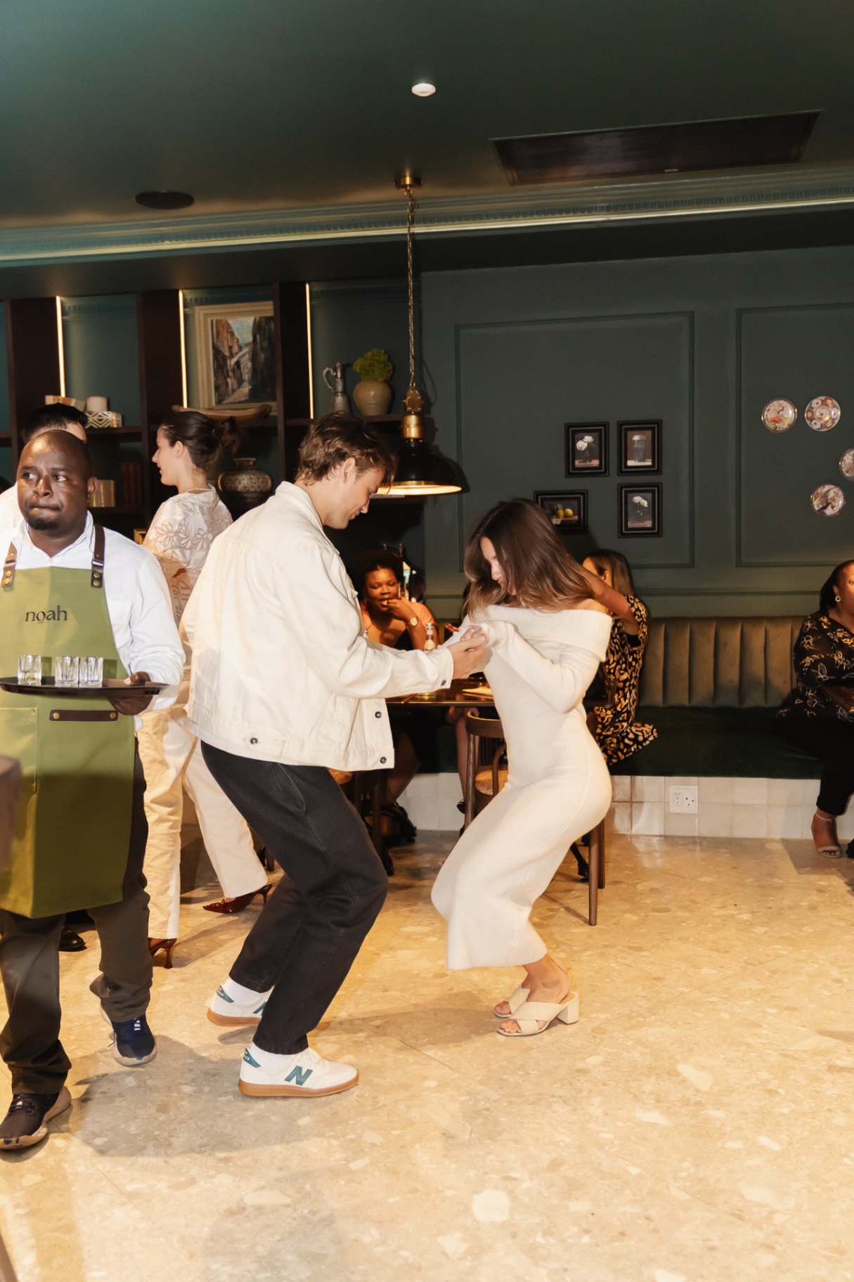 Dance floor moment at Noah Cape Town with waiter passing by on First Thursdays
