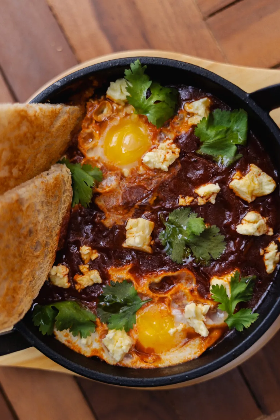 North African shakshuka with poached eggs and crusty sourdough at Noah Cape Town