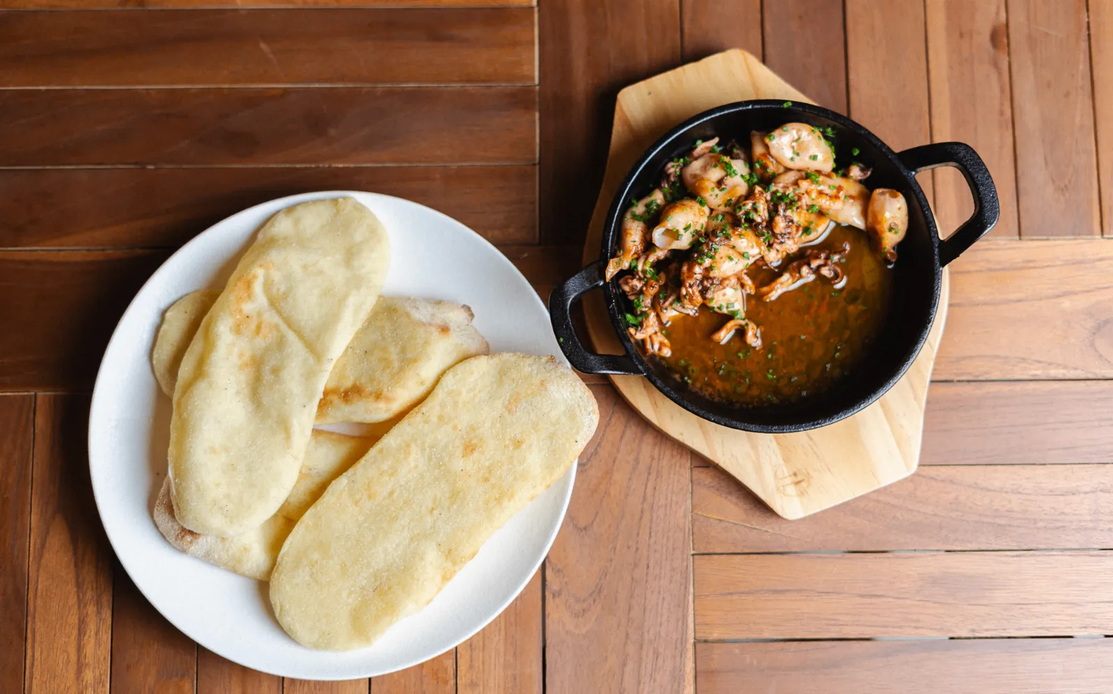 Charred West Coast calamari served with house flatbread