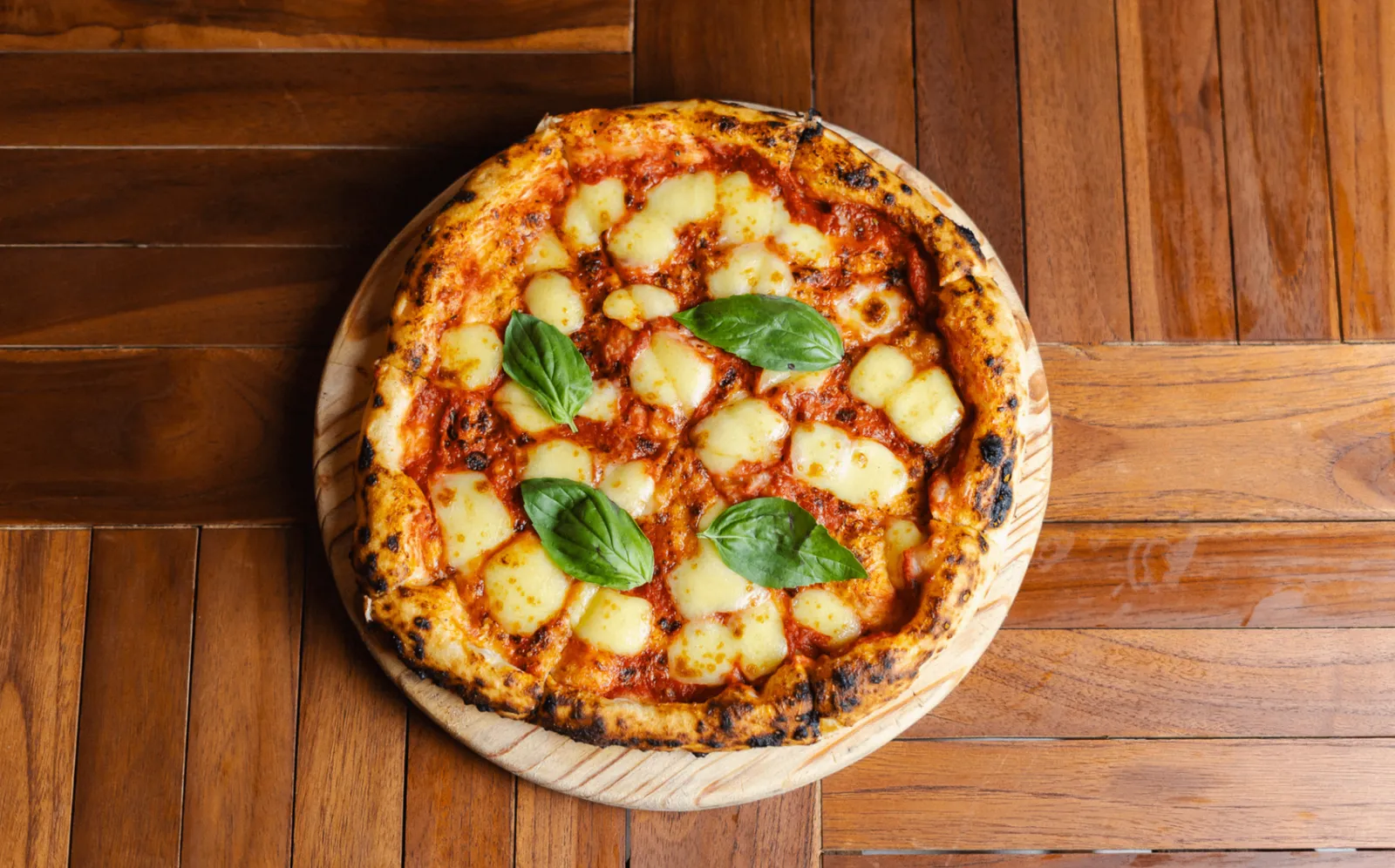 Wood-fired Margherita pizza with San Marzano tomato, mozzarella and basil
