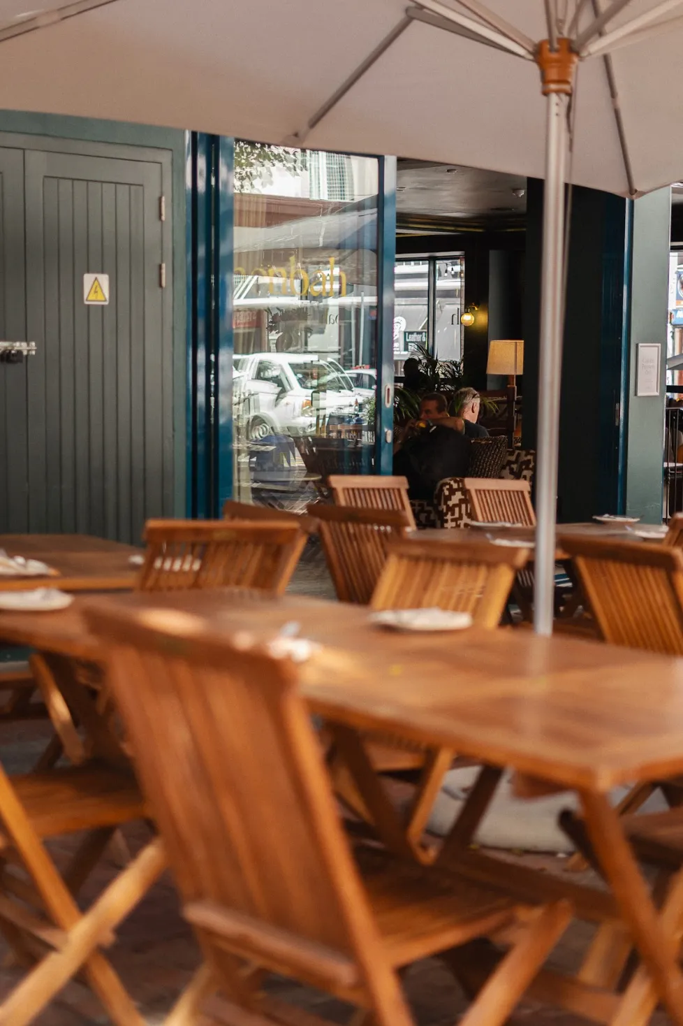 Noah Cape Town terrace entrance with leafy planters and street-side tables